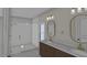 Modern bathroom features a glass shower, oval mirrors, and brass fixtures, blending style and functionality at 2603 Vineyard St, Durham, NC 27707