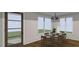 A dining room filled with natural light, showcasing a classic table set for six and a pendant light fixture at 2603 Vineyard St, Durham, NC 27707