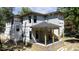 New home's exterior featuring a brick foundation and a covered porch area, nearing completion at 2603 Vineyard St, Durham, NC 27707