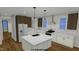 Modern kitchen featuring white cabinets, stainless steel appliances, island, and hardwood flooring at 2603 Vineyard St, Durham, NC 27707