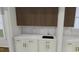 Features a convenient wet bar with modern white marble countertop, gold fixtures and ample cabinet space at 2603 Vineyard St, Durham, NC 27707