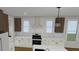 Open concept kitchen with island, white cabinets, and stainless steel appliances at 2603 Vineyard St, Durham, NC 27707