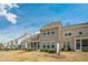 View of back of house with screened porch and large backyard on a sunny day at 310 Shale Creek Dr, Durham, NC 27703