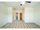 A clean carpeted bedroom features neutral tones, a ceiling fan, and multiple doorways, awaiting personalization at 310 Shale Creek Dr, Durham, NC 27703