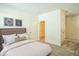Bright bedroom with neutral walls, carpet, and two doors leading to a closet and hallway at 310 Shale Creek Dr, Durham, NC 27703