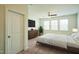 This cozy bedroom features soft carpet, natural lighting from the windows, and a ceiling fan for added comfort at 310 Shale Creek Dr, Durham, NC 27703