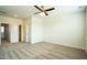 Bright bedroom featuring carpet, ceiling fan, and two entry doors, one with a walk-in closet at 310 Shale Creek Dr, Durham, NC 27703