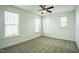 Bright and open carpeted bedroom with three windows at 310 Shale Creek Dr, Durham, NC 27703