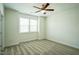 A clean, carpeted bedroom with natural light and ceiling fan, ready to be styled into a comforting sanctuary at 310 Shale Creek Dr, Durham, NC 27703