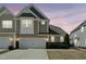 Two-story townhome with a white garage door, stone accents and neat landscaping at 310 Shale Creek Dr, Durham, NC 27703