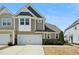 Townhome includes a two-car garage and beautiful stone accents under the windows at 310 Shale Creek Dr, Durham, NC 27703