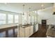 Open-concept kitchen with island seating, stainless appliances, and sightlines to the living area at 310 Shale Creek Dr, Durham, NC 27703