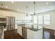 Well-lit kitchen featuring stainless appliances, ample white cabinetry, and a center island at 310 Shale Creek Dr, Durham, NC 27703