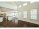 Open concept living room to kitchen with hardwood floors, vaulted ceiling, and fireplace at 310 Shale Creek Dr, Durham, NC 27703
