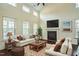 Bright living room featuring vaulted ceilings, fireplace, and hardwood floors at 310 Shale Creek Dr, Durham, NC 27703