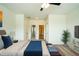 Spacious bedroom featuring neutral walls, ceiling fan, adjacent bathroom, and sitting area at the end of the bed at 310 Shale Creek Dr, Durham, NC 27703