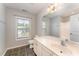 Bright bathroom with a large mirror, vanity, and tiled floors at 318 Sylvias Ct, Durham, NC 27703