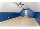 Upstairs bedroom with dark blue accent wall, carpet, and ceiling fan at 318 Sylvias Ct, Durham, NC 27703