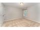 A simple bedroom with a neutral carpet, one window, and a ceiling light at 318 Sylvias Ct, Durham, NC 27703