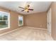 This bedroom features neutral carpet, two windows for natural light, and a ceiling fan at 318 Sylvias Ct, Durham, NC 27703