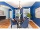 Cozy dining room with hardwood floors, chandelier, and blue accent wall at 318 Sylvias Ct, Durham, NC 27703