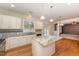 Well-lit kitchen boasts white cabinets, granite countertops, stainless appliances and kitchen island at 318 Sylvias Ct, Durham, NC 27703