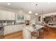 Well-lit kitchen boasts white cabinets, granite countertops, stainless appliances, breakfast bar and kitchen island at 318 Sylvias Ct, Durham, NC 27703