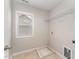Simple laundry room with tiled floor, a window, and a shelf at 318 Sylvias Ct, Durham, NC 27703