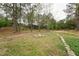 Private backyard with an outdoor stone firepit area surrounded by a circle of stone seats at 327F Bobbitt Rd, Clayton, NC 27520