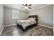 Cozy bedroom with ceiling fan, natural light, and wood-style flooring at 327F Bobbitt Rd, Clayton, NC 27520
