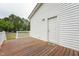 Wood deck with white siding on the house and a covered grill for outdoor living at 327F Bobbitt Rd, Clayton, NC 27520