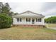 Charming single-story home with a welcoming front porch, white siding, and blue shutters at 327F Bobbitt Rd, Clayton, NC 27520