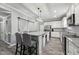 Spacious kitchen with white cabinets, granite countertops, stainless steel appliances and a large island at 327F Bobbitt Rd, Clayton, NC 27520