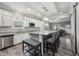 Open kitchen featuring white cabinets, a large island with seating, and stainless steel appliances at 327F Bobbitt Rd, Clayton, NC 27520