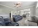 Spacious living room with hardwood floors, grey walls, and an open view to the kitchen at 327F Bobbitt Rd, Clayton, NC 27520