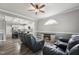 Open concept living room with hardwood floors, ceiling fan, and open view to the kitchen at 327F Bobbitt Rd, Clayton, NC 27520