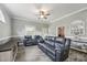 Comfortable living room with grey walls, hardwood floors, ceiling fan, and cozy seating at 327F Bobbitt Rd, Clayton, NC 27520