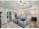 Spacious main bedroom features tray ceiling, ceiling fan, and en-suite bathroom with walk-in closet at 327F Bobbitt Rd, Clayton, NC 27520