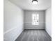 A gray bedroom featuring carpet flooring and natural light at 350 Gilman Ln # 104, Raleigh, NC 27610