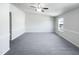 Bright bedroom features a ceiling fan, a large window, and soft carpet flooring at 350 Gilman Ln # 104, Raleigh, NC 27610
