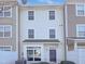 Townhome exterior with neutral siding, a front entrance, and visible windows at 350 Gilman Ln # 104, Raleigh, NC 27610