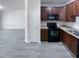 Well-lit kitchen area with dark wood cabinets and modern appliances at 350 Gilman Ln # 104, Raleigh, NC 27610