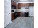 Cozy kitchen with dark wood cabinets and modern appliances at 350 Gilman Ln # 104, Raleigh, NC 27610