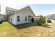 An outdoor patio features the backyard of the home with light siding and brown grass at 36 Labradoodle Ct, Garner, NC 27529