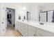 Well-lit bathroom boasts double sinks, a large mirror, and access to a walk-in closet at 36 Labradoodle Ct, Garner, NC 27529
