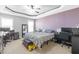 Spacious bedroom with tray ceiling, ceiling fan, and ample space for a bed and desks at 36 Labradoodle Ct, Garner, NC 27529