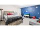 Bedroom with space themed wall features a queen bed and dresser with TV on top at 36 Labradoodle Ct, Garner, NC 27529