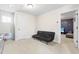 Carpeted bonus room features a black futon and a view into another room at 36 Labradoodle Ct, Garner, NC 27529