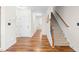 Bright entryway with hardwood floors and a staircase, creating a welcoming first impression at 36 Labradoodle Ct, Garner, NC 27529
