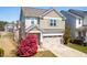 Two-story home with a two car garage, appealing curb appeal, and mature landscaping at 36 Labradoodle Ct, Garner, NC 27529